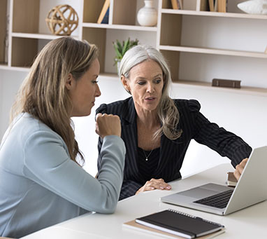 Professional consultation. Experienced senior businesswoman bank manager financial advisor meet with female client customer in work office give advice support explain contract details using notebook
